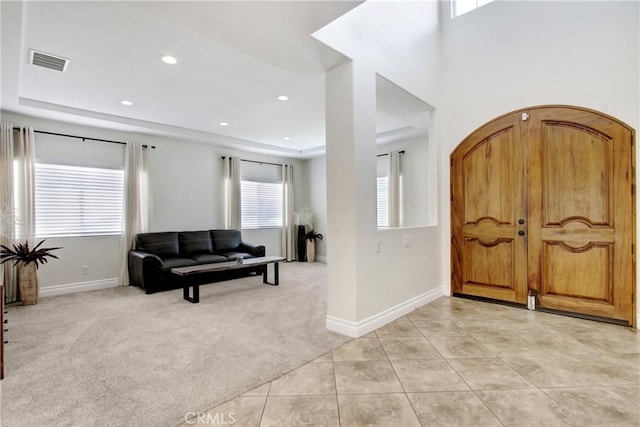 foyer entrance featuring recessed lighting, light tile patterned floors, light carpet, baseboards, and visible vents