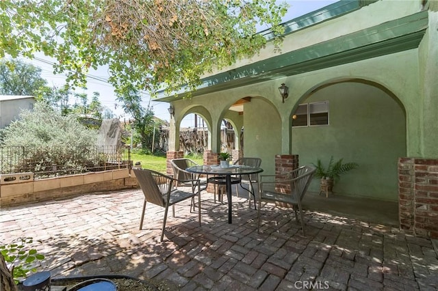view of patio with fence and outdoor dining area