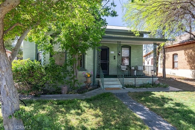 view of front of property with a front yard and covered porch