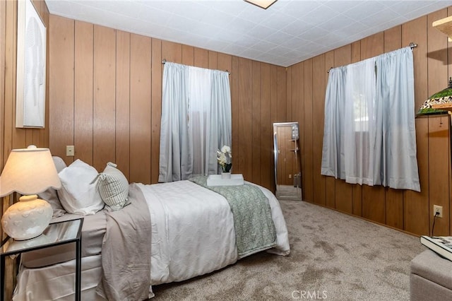 carpeted bedroom with wooden walls