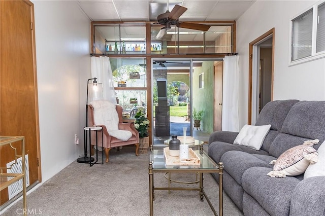carpeted living room with ceiling fan