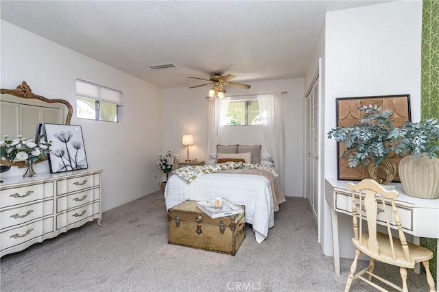 bedroom with carpet floors, multiple windows, a closet, and visible vents