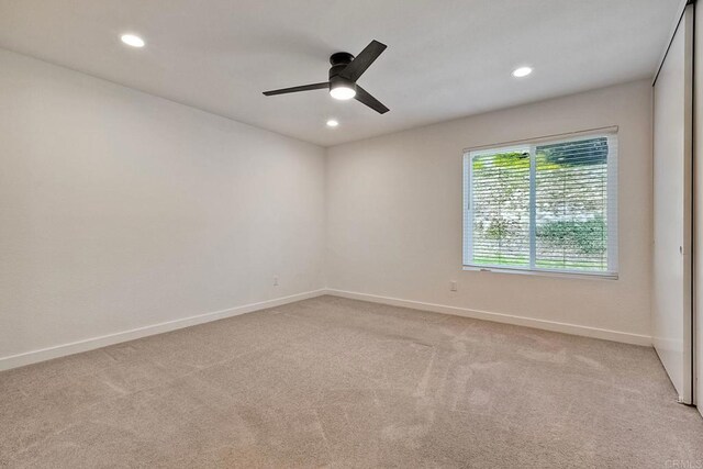 empty room with ceiling fan, baseboards, recessed lighting, and light colored carpet