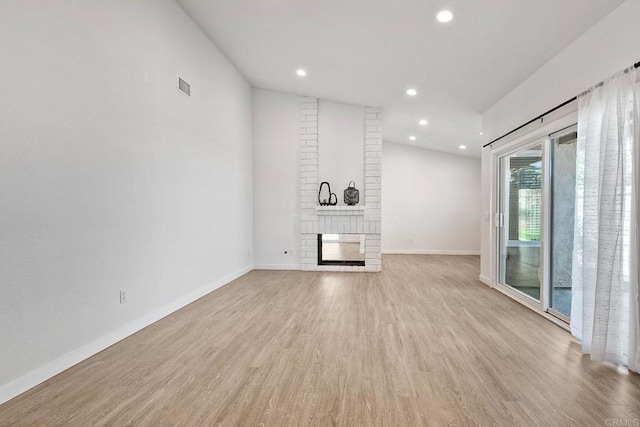 unfurnished living room featuring recessed lighting, wood finished floors, visible vents, baseboards, and a brick fireplace