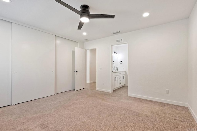 unfurnished bedroom with visible vents, recessed lighting, a closet, and light colored carpet