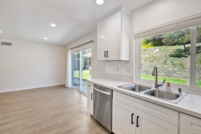 kitchen featuring recessed lighting, light countertops, visible vents, stainless steel dishwasher, and a sink