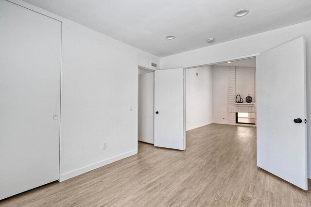 interior space featuring baseboards, recessed lighting, visible vents, and light wood-type flooring