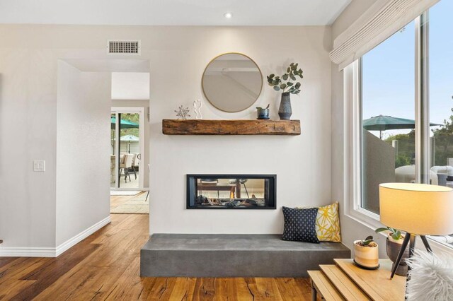 1024 Cottage Way, Encinitas, CA 92024 - living area with wood finished floors, baseboards, recessed lighting, and a multi sided fireplace
