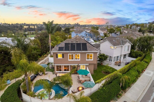 1024 Cottage Way, Encinitas, CA 92024 - rear view of house featuring a fenced backyard, outdoor dining space, a patio area, and roof mounted solar panels