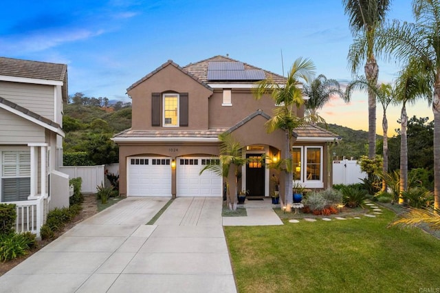1024 Cottage Way, Encinitas, CA 92024 - view of front of property featuring an attached garage, stucco siding, solar panels, concrete driveway, and a tiled roof