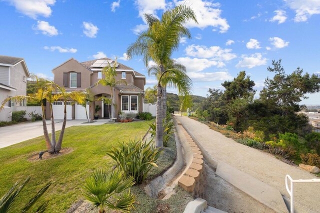 1024 Cottage Way, Encinitas, CA 92024 - view of front facade featuring driveway, a garage, roof mounted solar panels, and stucco siding
