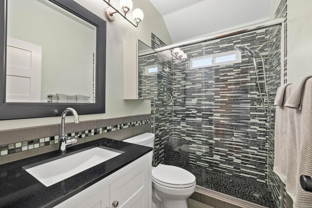 1024 Cottage Way, Encinitas, CA 92024 - bathroom featuring a shower stall, toilet, vanity, tile walls, and lofted ceiling
