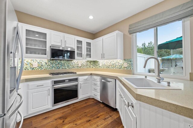 1024 Cottage Way, Encinitas, CA 92024 - kitchen featuring stainless steel appliances, a sink, white cabinets, dark wood-style flooring, and recessed lighting