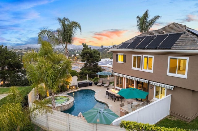 1024 Cottage Way, Encinitas, CA 92024 - pool at dusk with a fenced backyard, a patio area, a pool with connected hot tub, and outdoor dining space
