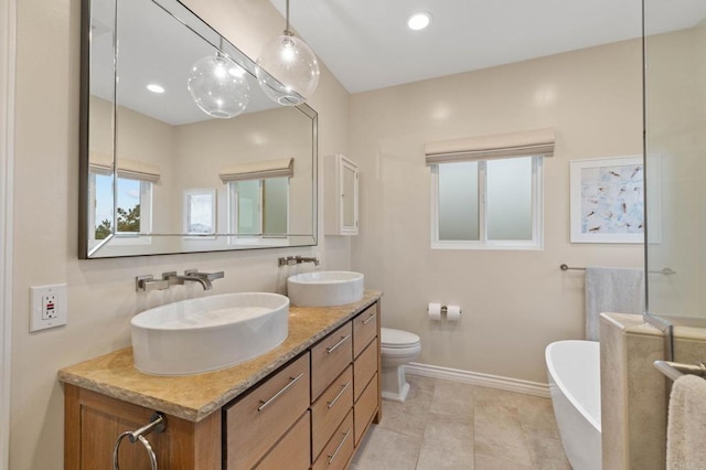 1024 Cottage Way, Encinitas, CA 92024 - full bathroom featuring a freestanding tub, double vanity, baseboards, toilet, and recessed lighting
