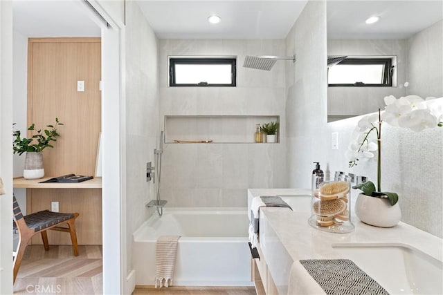 full bath with double vanity and a healthy amount of sunlight