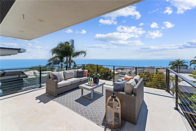 balcony with a water view and an outdoor hangout area