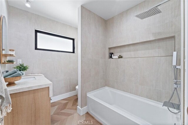 full bath featuring toilet, vanity, and baseboards