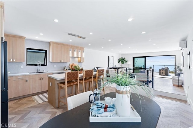 dining area with an AC wall unit and recessed lighting