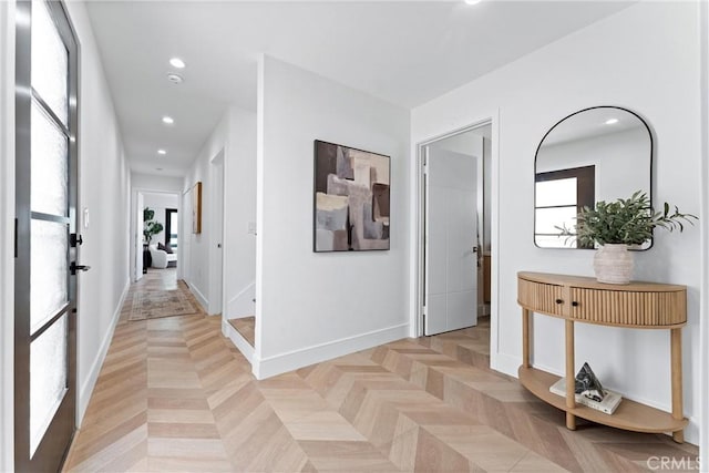 hall with recessed lighting and baseboards