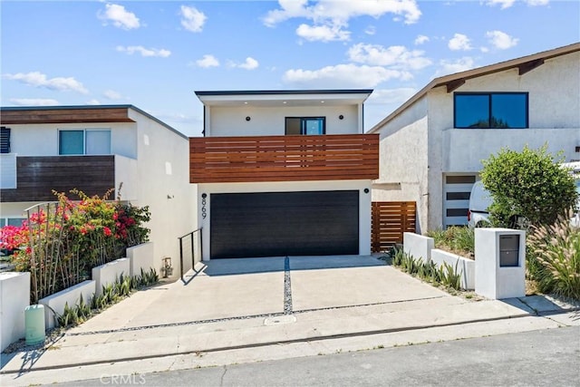 modern home with concrete driveway and stucco siding
