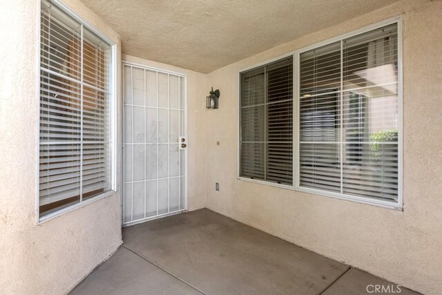 11530 Oak St, Apple Valley, CA 92308 - doorway to property with stucco siding and a patio area