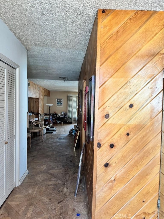 hallway featuring a textured ceiling