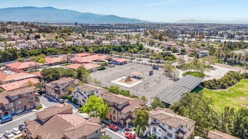 birds eye view of property with a mountain view and a residential view