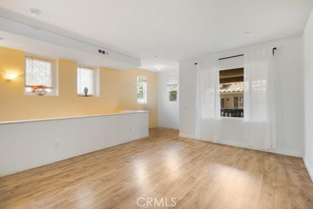 unfurnished room featuring visible vents and wood finished floors