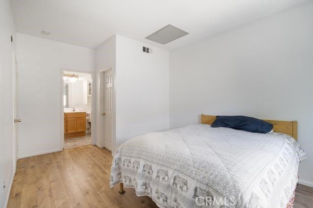 bedroom featuring baseboards and light wood-type flooring