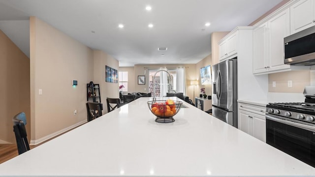 1771 Laurelwood Way, Oceanside, CA 92056 - kitchen with appliances with stainless steel finishes, a large island, white cabinetry, light countertops, and recessed lighting