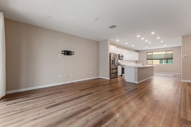 1771 Laurelwood Way, Oceanside, CA 92056 - unfurnished living room featuring light wood-type flooring and recessed lighting