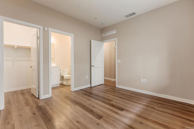 1771 Laurelwood Way, Oceanside, CA 92056 - unfurnished bedroom with light wood finished floors, a spacious closet, a closet, and ensuite bathroom