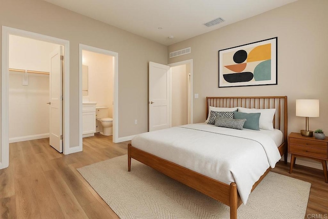 1771 Laurelwood Way, Oceanside, CA 92056 - bedroom with light wood-style flooring, a walk in closet, connected bathroom, and a closet