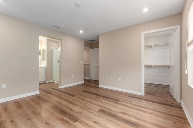1771 Laurelwood Way, Oceanside, CA 92056 - unfurnished bedroom with recessed lighting, light wood-style flooring, a spacious closet, a closet, and connected bathroom