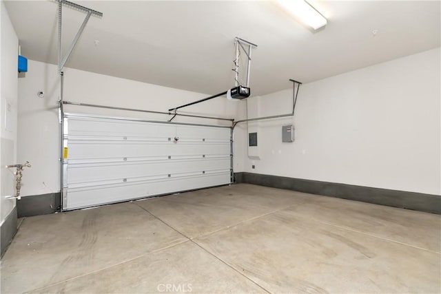garage with electric panel and a garage door opener