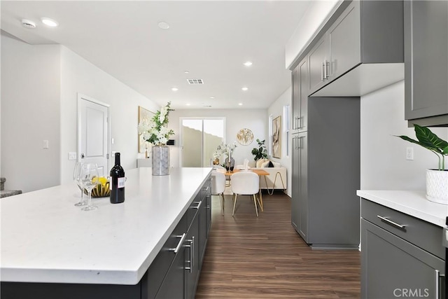 kitchen with dark wood-style flooring, light countertops, visible vents, and recessed lighting