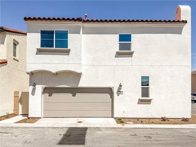 mediterranean / spanish-style home featuring stucco siding and an attached garage