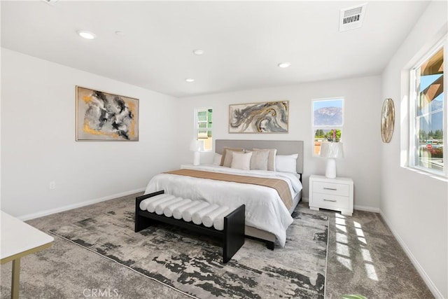 carpeted bedroom featuring recessed lighting, visible vents, and baseboards