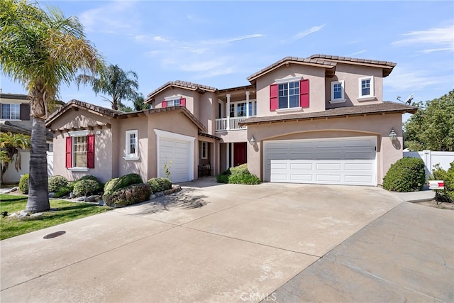 view of front of property with a garage, a tile roof, a balcony, stucco siding, and driveway