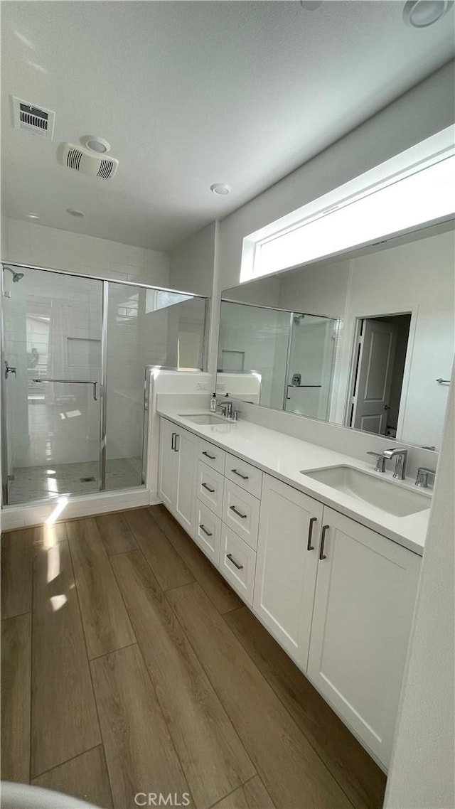 230 Sora, Irvine, CA 92618 - bathroom featuring a sink, visible vents, and wood finished floors