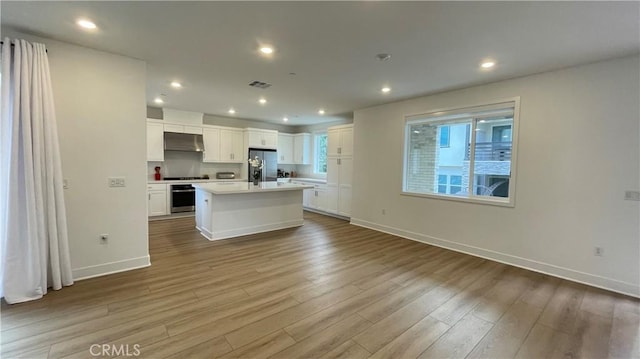 230 Sora, Irvine, CA 92618 - kitchen with white cabinets, visible vents, wood finished floors, light countertops, and appliances with stainless steel finishes
