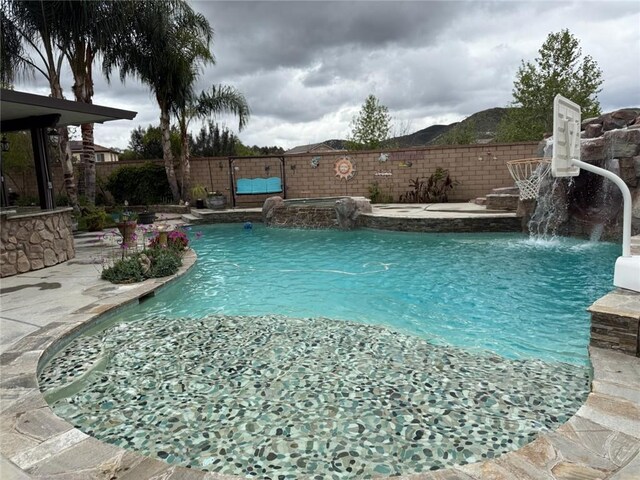 25279 Spur Branch Pl, Menifee, CA 92584 - view of pool with a fenced backyard, a pool with connected hot tub, and a patio