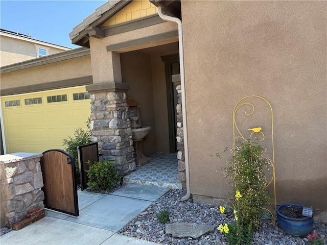 25279 Spur Branch Pl, Menifee, CA 92584 - view of exterior entry featuring stucco siding and an attached garage
