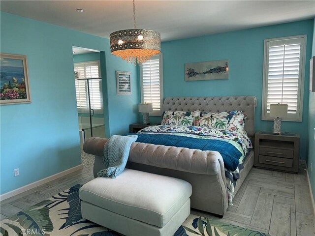 25279 Spur Branch Pl, Menifee, CA 92584 - bedroom with baseboards and a chandelier