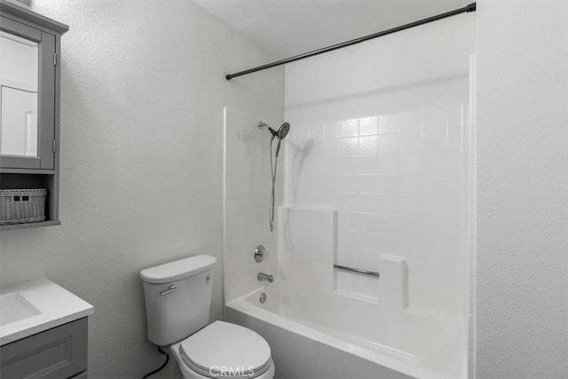 bathroom with toilet, vanity, and  shower combination