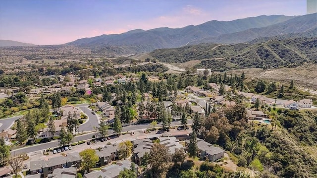 aerial view at dusk featuring a mountain view