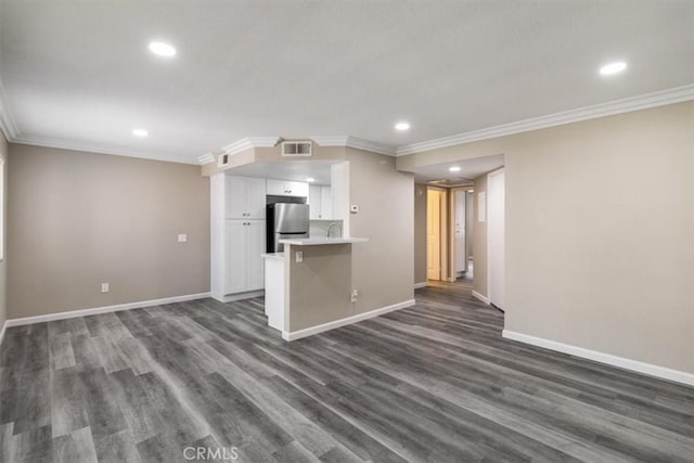 unfurnished living room with ornamental molding, visible vents, baseboards, and dark wood-style flooring
