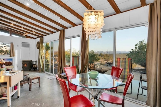 63854 Orion Rd, Joshua Tree, CA 92252 - sunroom featuring a wood stove, plenty of natural light, and a wall mounted AC
