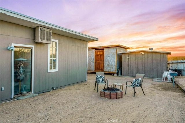 63854 Orion Rd, Joshua Tree, CA 92252 - view of patio / terrace featuring an outdoor fire pit and a wall mounted air conditioner